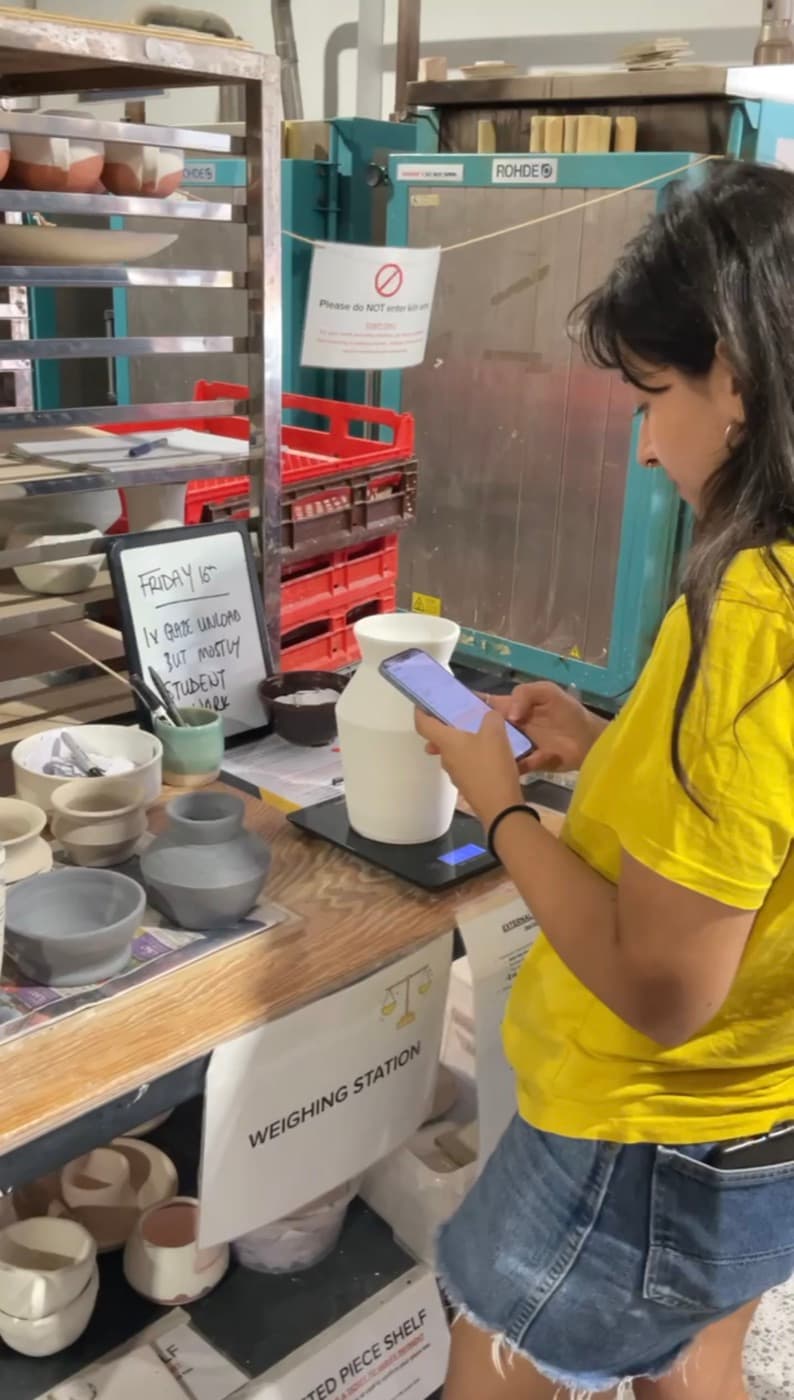 A potter logging her work in the MudBuddy app at ClayGround studio.